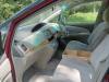 Dashboard and front seats of the red JAK653 Toyota Estima, plywood console box between the seats