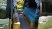 Side door open on the FYC899 campervan, bed cushions on the timber base with the bench alongside