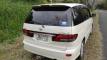 Rear three-quarter view of the white Toyota Estima campervan JBB773, green self-contained sticker in the window