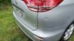 Close-up of the HMC107 Toyota Estima's rear bumper and tailgate, showing a small dent above the bumper