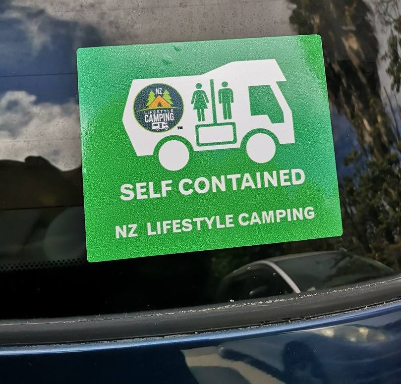 Green self-contained sticker on the windscreen of the FDK492 Toyota Estima campervan