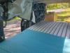 Inside the FDK492 campervan looking forward over the bed to the sink unit and the open side door