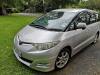 Silver 2007 Toyota Estima self-contained campervan for sale, registration JTQ214, parked on grass