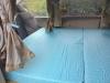 The GRH325 campervan's double bed made up across the van, curtains tied back