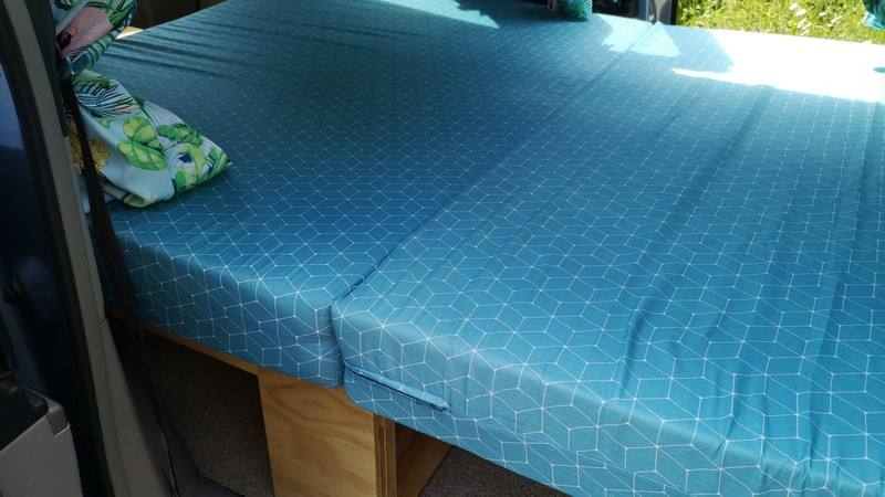 Close view of the made-up double bed in the blue DJR846 Toyota Estima campervan