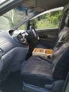 Driver's side of the FPS382 Toyota Estima cab, seat covers and console box between the seats