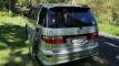 Rear three-quarter view of the silver Toyota Estima campervan FYC899 on a country road