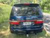 Back of the dark blue Toyota Estima campervan with registration FDK492