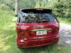 Back of the red Toyota Estima campervan with registration JAK653