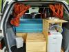 Tailgate open on the HDP33 campervan, showing the kitchen unit with sink, fresh water container and rubbish bin