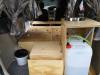 Kitchen unit in the KZR927 campervan with stainless sink, fresh water container and rubbish bin