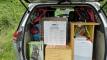 The HMC107 campervan loaded for a trip, with the electric cooker, camping gear and the fresh water container