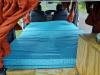 Inside the HDP33 campervan looking forward over the made-up bed to the front seats, sink unit on the right