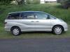 Side view of the silver 2004 Toyota Estima campervan GRH325 parked on a grass verge
