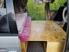 Plywood table board laid across the bed base of the FPS382 campervan