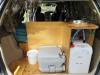 Kitchen unit in the KBZ76 campervan with stainless sink, portable toilet and fresh water container