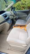 Front seats, steering wheel and timber console shelf of the EYC409 Toyota Estima campervan