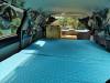 Looking forward across the JTQ214 campervan's bed to the sink unit and the cab