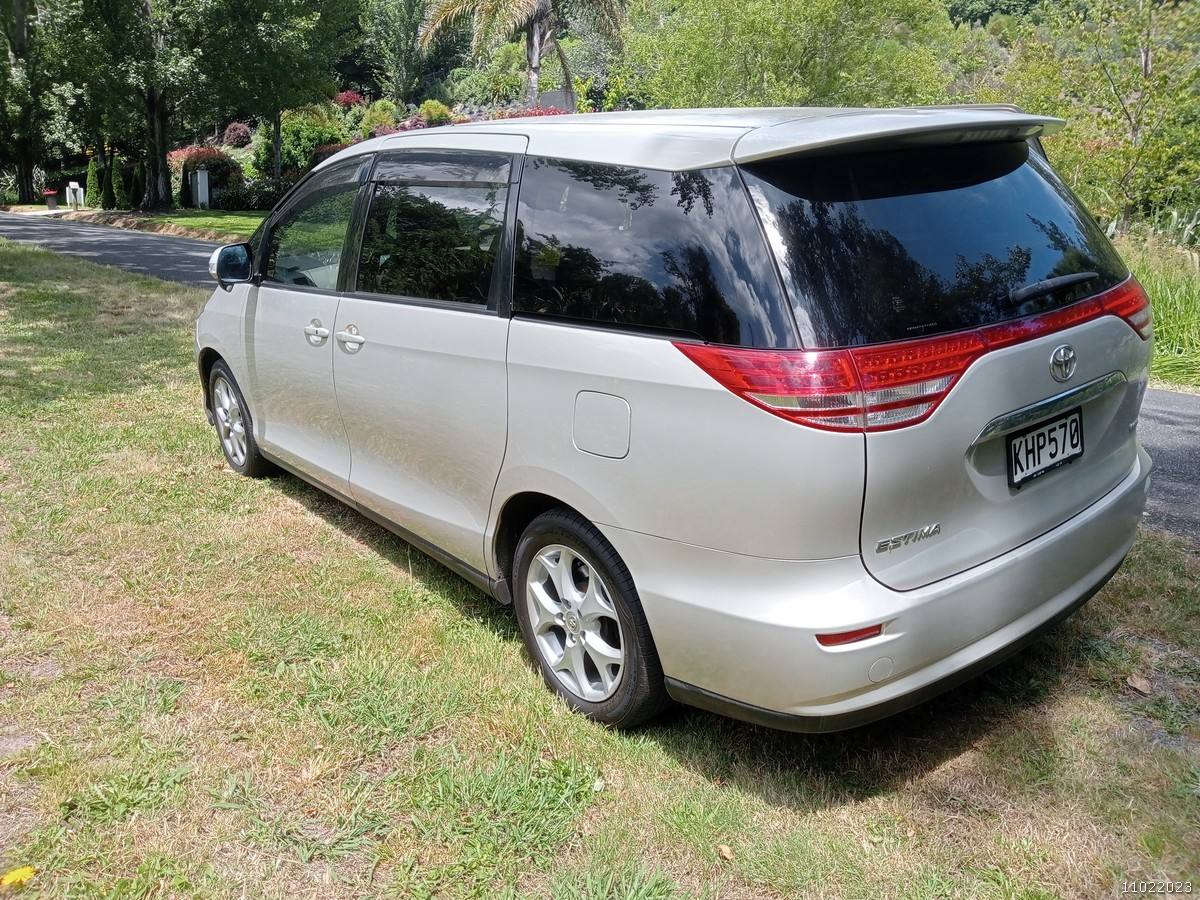 Rear three-quarter view of the gold 2006 Toyota Estima campervan KHP570