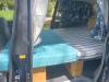 Side door open on the FDK492 campervan, bed part made up on its plywood base