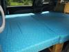 Close view of the made-up double bed in the JTQ214 Toyota Estima campervan