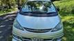 Front of the silver FYC899 Toyota Estima campervan parked on a shaded country road