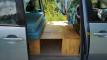 Side door open on the DJR846 campervan, bed cushion on its plywood base with the step box alongside