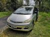Front three-quarter view of the silver KBZ76 Toyota Estima campervan parked on grass