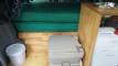 Portable toilet and rubbish bin beside the folded bed cushions in the FDK492 campervan