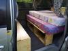 Side door open on the FPS382 campervan, two mattresses on the bed base with storage underneath