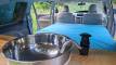 Stainless sink and hand pump tap in the EYC409 campervan, with the made-up bed behind