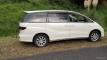 Side view of the white 2005 Toyota Estima campervan JBB773 parked on a grass verge