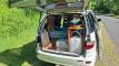 Tailgate open on the FAC789 campervan, showing the kitchen bench, sink, portable toilet and water container