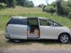 Side view of the gold Toyota Estima campervan KHP570 with the side door open