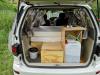 Tailgate open on the KZR927 campervan, showing the bed, kitchen unit and fresh water container