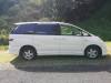 Side view of the white 2001 Toyota Estima campervan FQK81 parked on grass