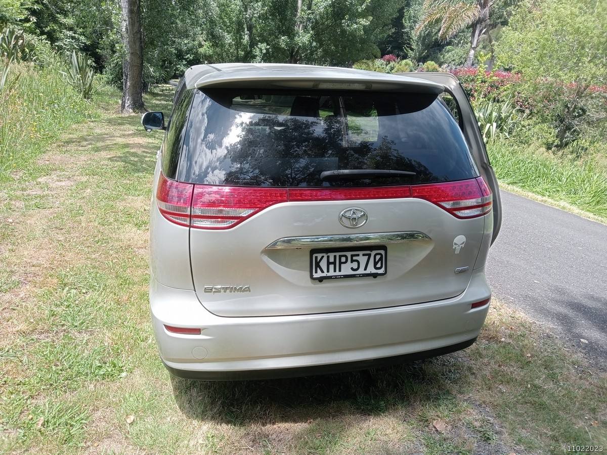 Back of the gold Toyota Estima campervan with registration KHP570