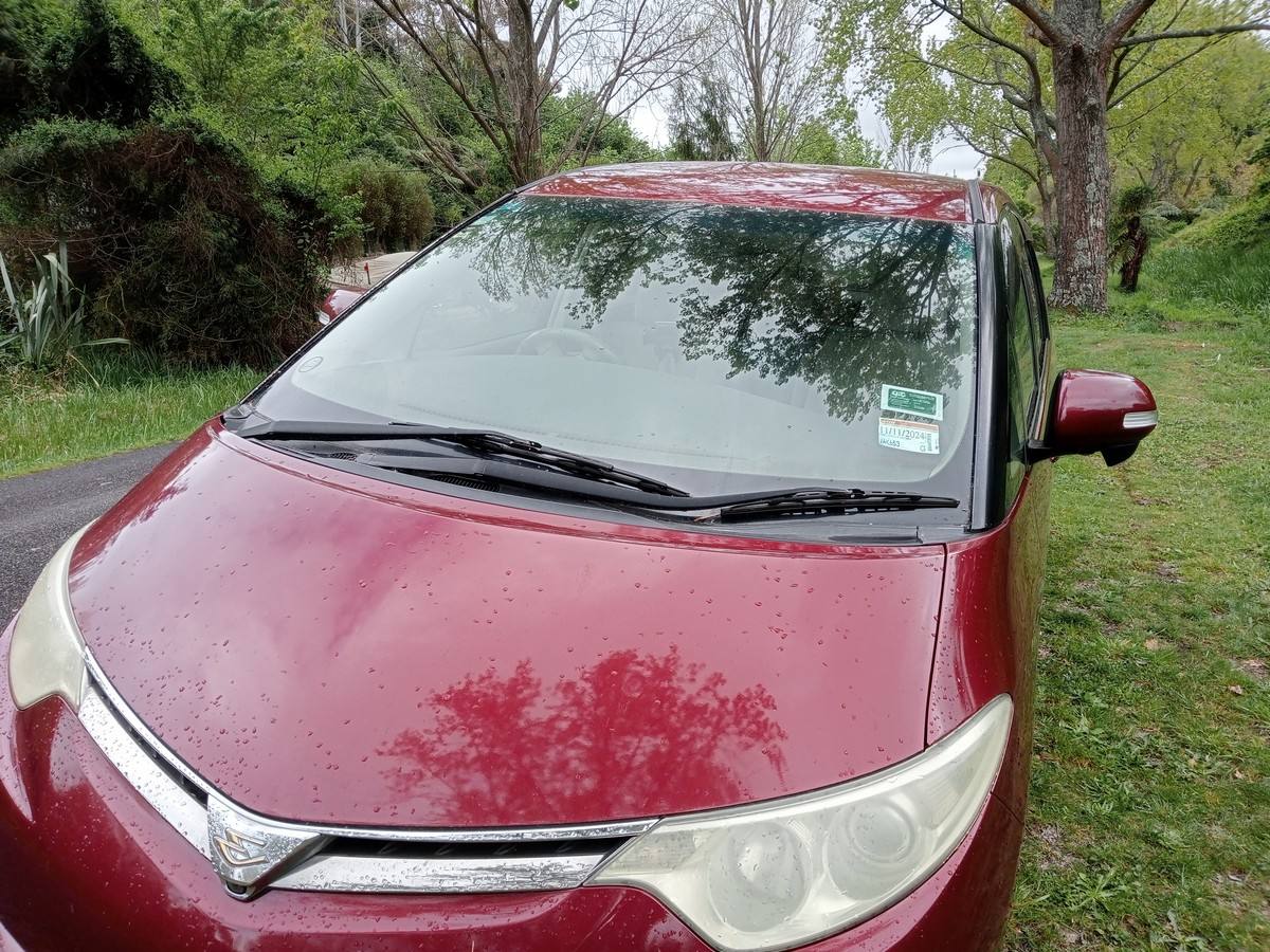 Bonnet and windscreen of the red JAK653 Toyota Estima campervan