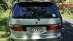 Back of the silver Toyota Estima campervan with registration FYC899 and the green self-contained sticker